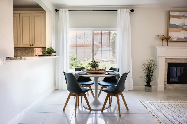 dining area with baseboards, a healthy amount of sunlight, and light tile patterned flooring