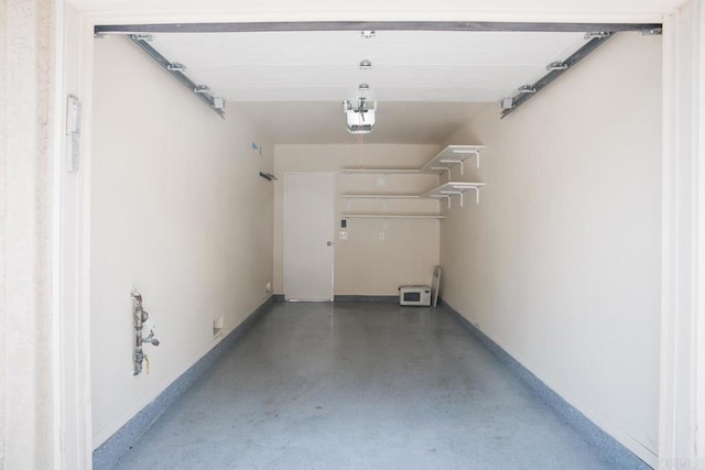 garage featuring baseboards and a garage door opener