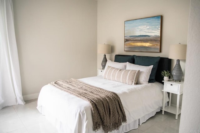 bedroom featuring baseboards and light tile patterned flooring