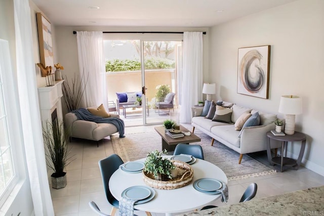 living area featuring baseboards, tile patterned flooring, and a premium fireplace