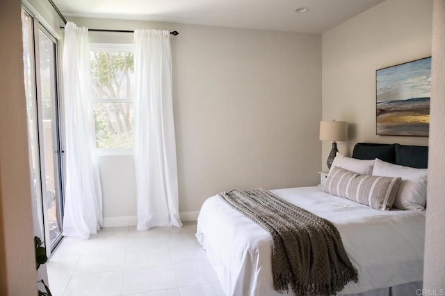 bedroom with baseboards and light tile patterned flooring