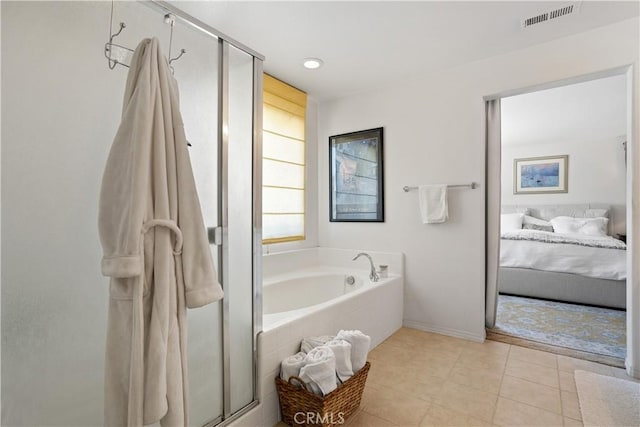 ensuite bathroom featuring a garden tub, visible vents, connected bathroom, and a stall shower