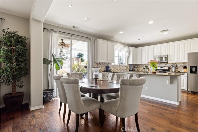 dining area with dark wood-style floors, visible vents, and recessed lighting