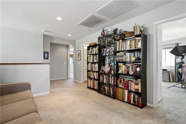 sitting room with visible vents, carpet flooring, and baseboards