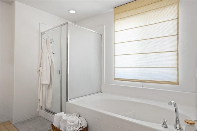full bath featuring a bath, tile patterned floors, and a stall shower