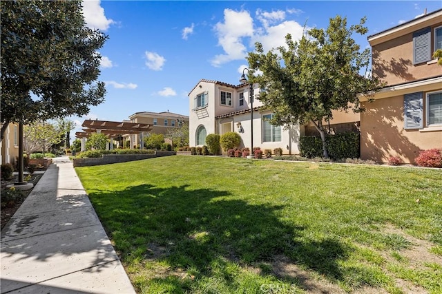 view of front of home with a pergola, a residential view, a front yard, and stucco siding