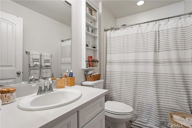 full bathroom featuring visible vents, toilet, and vanity