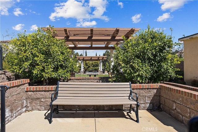view of property's community featuring a pergola and a patio area