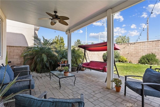 view of patio featuring a fenced backyard, central AC unit, an outdoor living space, and ceiling fan