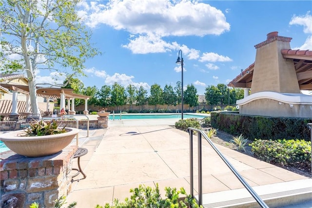 pool with fence, a patio, and a pergola