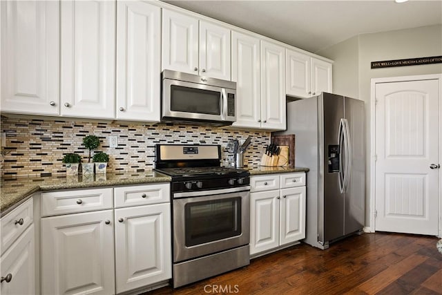 kitchen featuring decorative backsplash, stone countertops, stainless steel appliances, white cabinets, and dark wood-style flooring