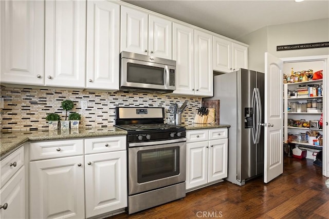 kitchen with stainless steel appliances, dark wood-type flooring, backsplash, and white cabinetry