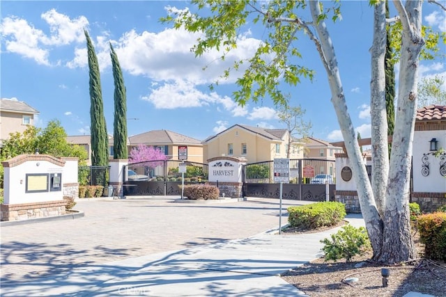 view of road with a residential view and a gated entry
