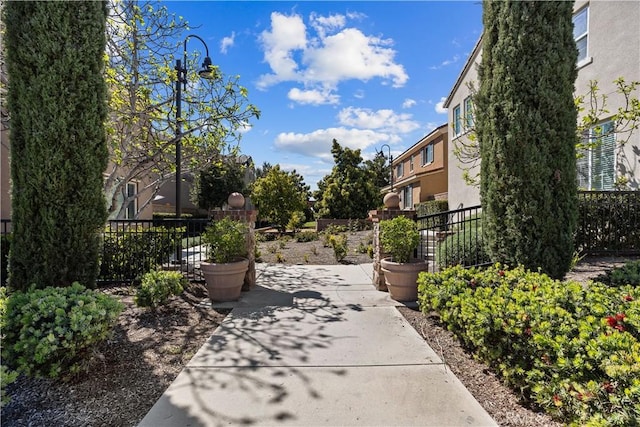 view of home's community with a patio and fence