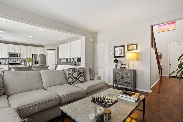 living room featuring baseboards, recessed lighting, and dark wood-style flooring