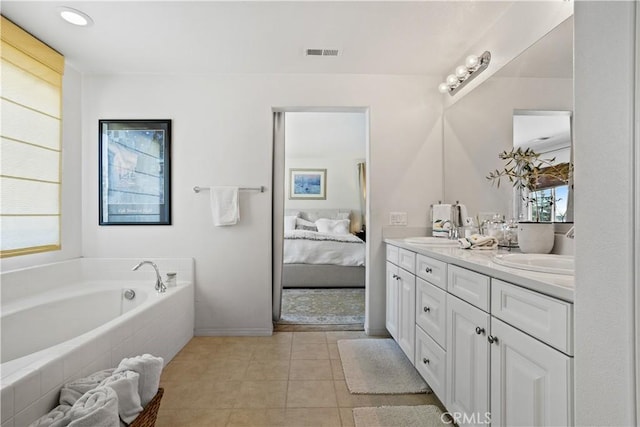 bathroom featuring a sink, double vanity, ensuite bathroom, visible vents, and a garden tub