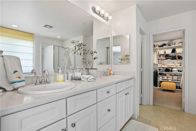 full bath featuring tile patterned floors, visible vents, a sink, and double vanity
