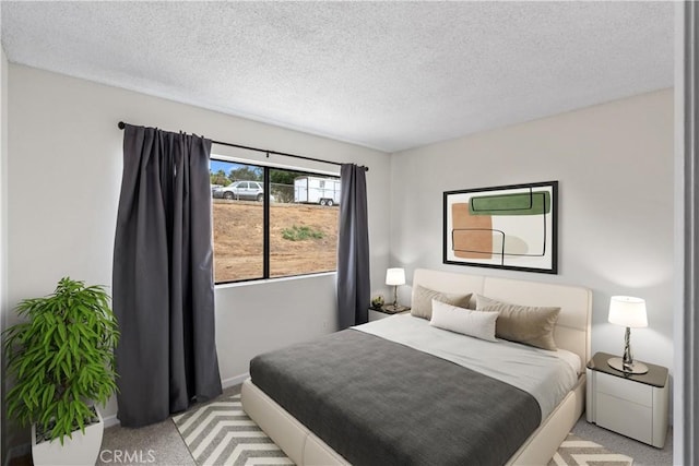 carpeted bedroom featuring a textured ceiling and baseboards