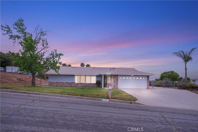 single story home with fence, a lawn, driveway, and a garage