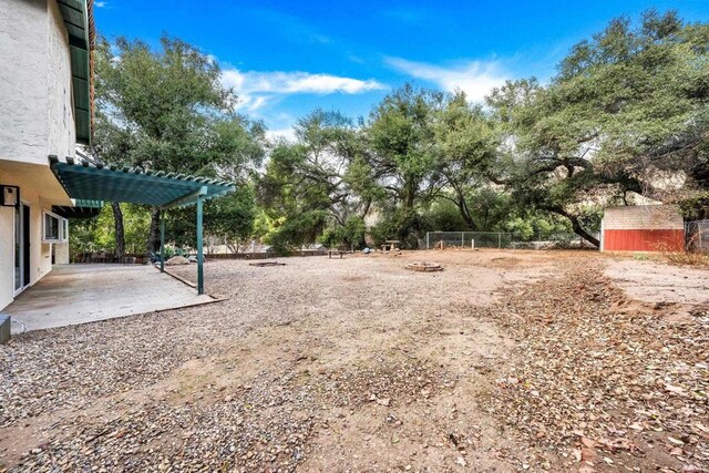 view of yard featuring fence, a patio area, and a pergola