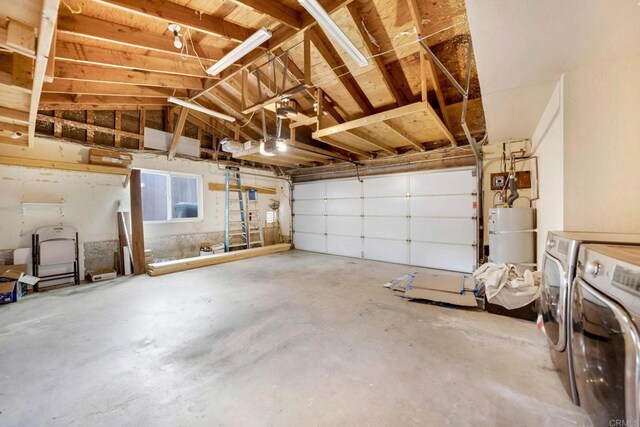 garage with water heater and washing machine and clothes dryer