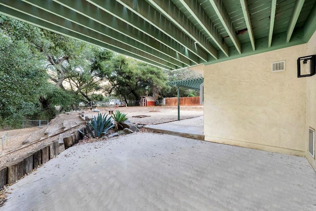 view of patio / terrace with fence and visible vents