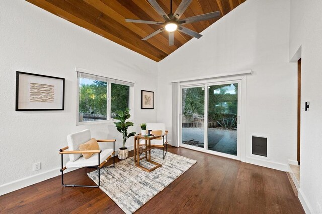 sitting room featuring high vaulted ceiling, wood finished floors, wood ceiling, ceiling fan, and baseboards