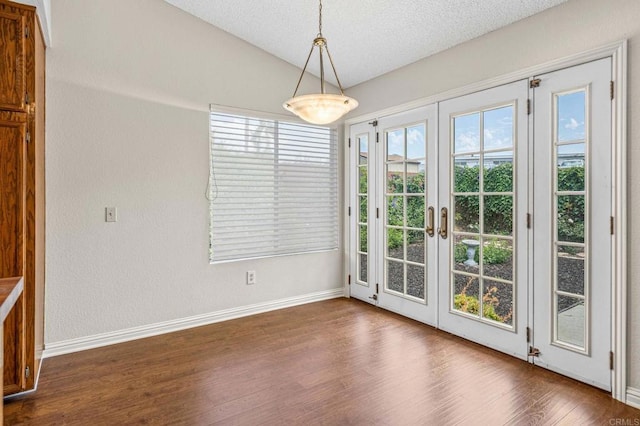 688 Via Encantada, Chula Vista, CA 91913 - unfurnished dining area with french doors, baseboards, dark wood-style floors, lofted ceiling, and a textured ceiling