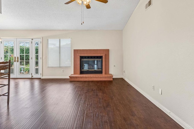 688 Via Encantada, Chula Vista, CA 91913 - unfurnished living room with baseboards, dark wood-style floors, a ceiling fan, a textured ceiling, and a fireplace