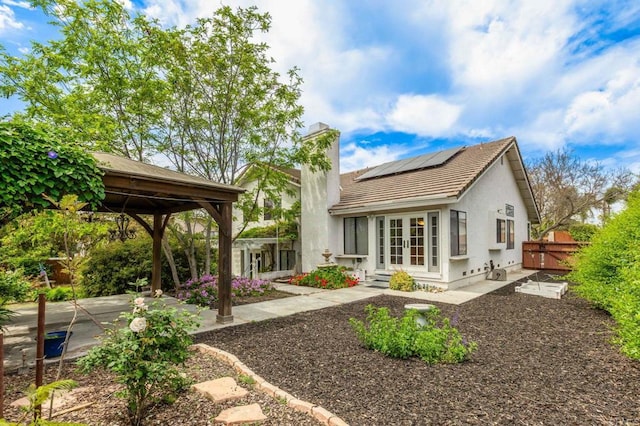 688 Via Encantada, Chula Vista, CA 91913 - rear view of house with french doors, roof mounted solar panels, a chimney, a tile roof, and a gazebo