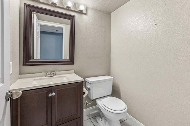 688 Via Encantada, Chula Vista, CA 91913 - bathroom with toilet, vanity, a textured wall, and baseboards