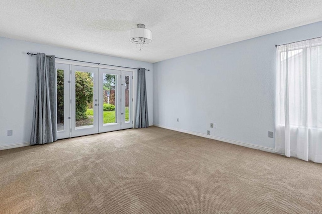 688 Via Encantada, Chula Vista, CA 91913 - carpeted empty room featuring french doors, healthy amount of natural light, a textured ceiling, and baseboards