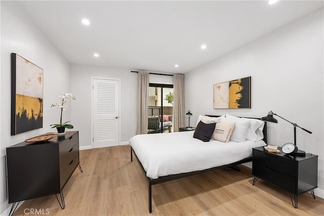 bedroom with light wood-type flooring, baseboards, and recessed lighting