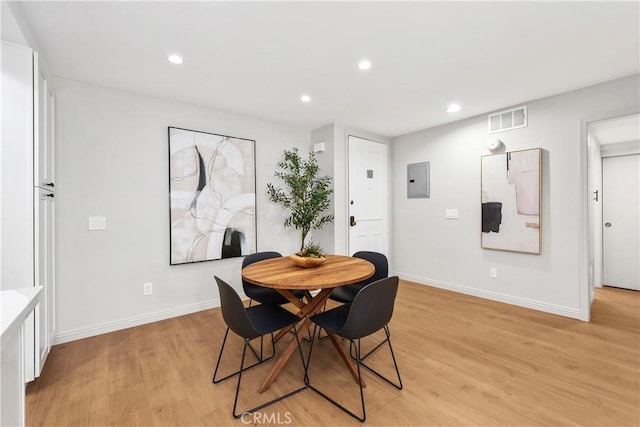 dining room featuring baseboards, light wood-style floors, visible vents, and recessed lighting