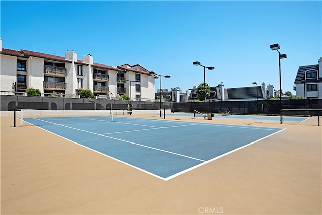 view of sport court featuring fence and community basketball court