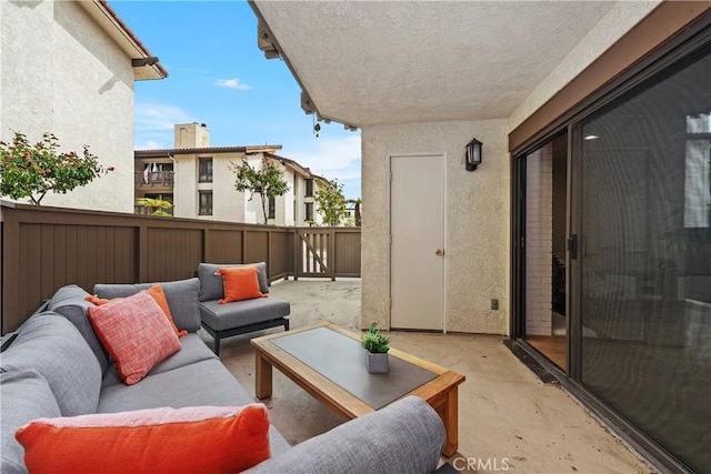 view of patio featuring outdoor lounge area and fence