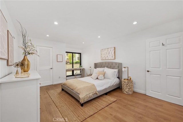 bedroom featuring light wood finished floors, baseboards, and recessed lighting