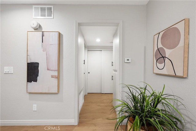 corridor featuring recessed lighting, baseboards, visible vents, and light wood-style flooring
