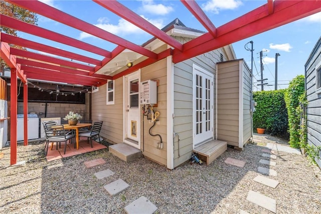 view of patio featuring washer / dryer and a pergola