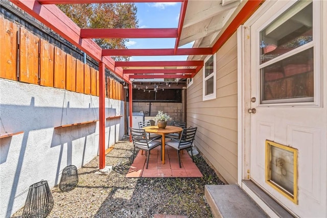 view of patio / terrace featuring fence and a pergola