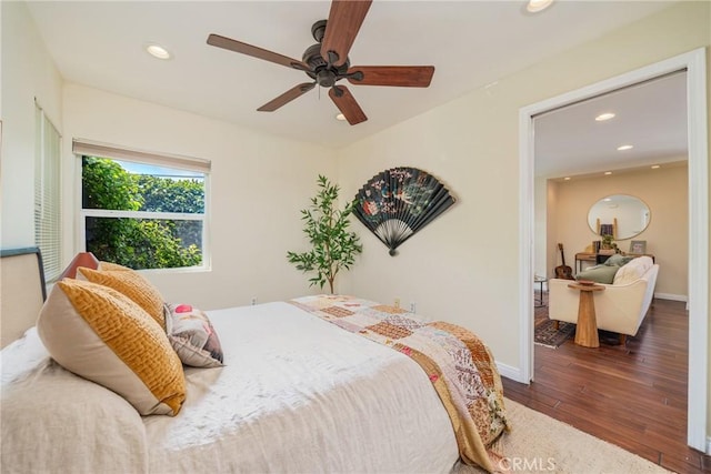 bedroom with recessed lighting, wood-type flooring, a ceiling fan, and baseboards