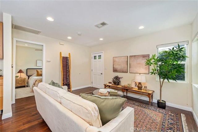 living room featuring dark wood-style floors, visible vents, and recessed lighting