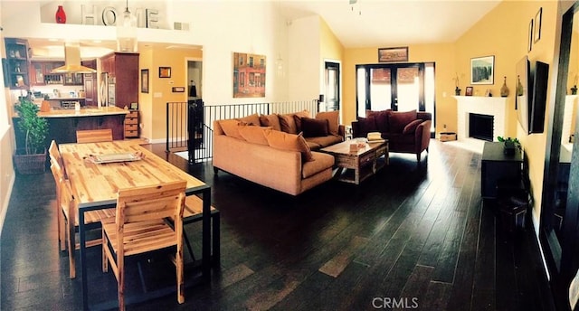 1904 Carnegie Ln Unit 2, Redondo Beach, CA 90278 - living area featuring dark wood-type flooring, vaulted ceiling, a fireplace, and visible vents