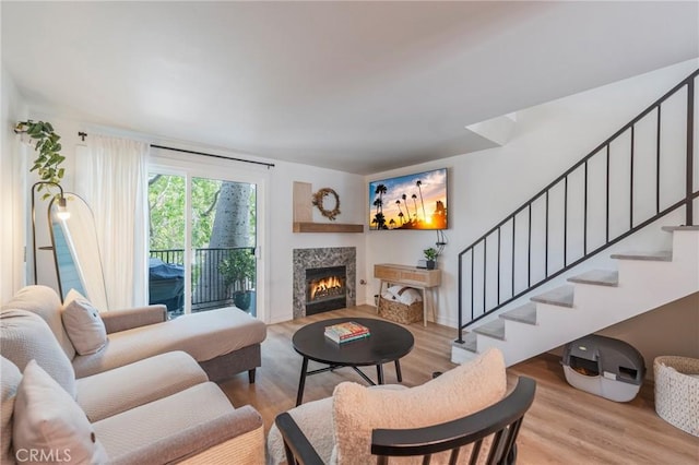 1600 Redondo Ave Unit 4, Long Beach, CA 90804 - living room featuring stairs, wood finished floors, and a lit fireplace