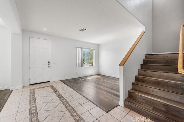 2613 Lincoln Ln, Palmdale, CA 93551 - entrance foyer with stairway, baseboards, and visible vents