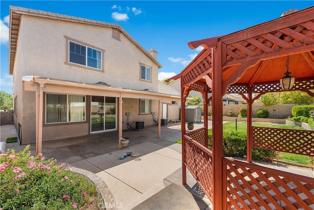 2613 Lincoln Ln, Palmdale, CA 93551 - exterior space featuring a storage unit, a gazebo, central air condition unit, fence, and an outdoor structure