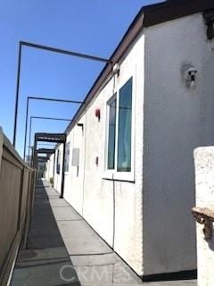 view of property exterior with fence and stucco siding