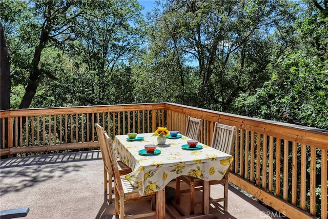 wooden terrace with outdoor dining area