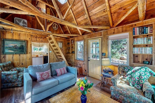 living area featuring stairway, wooden walls, wood finished floors, vaulted ceiling with beams, and wooden ceiling