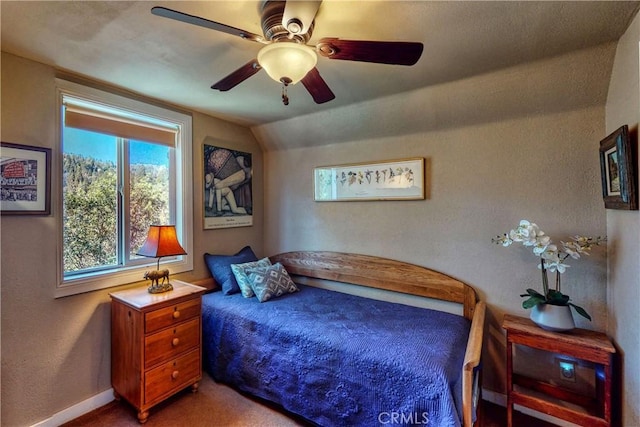 bedroom featuring ceiling fan, baseboards, carpet flooring, and vaulted ceiling